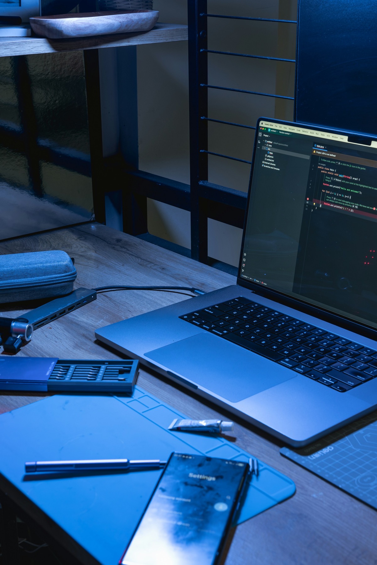 Laptop and smartphones showing the same app interface, illustrating Expo cross-platform development for iOS and Android